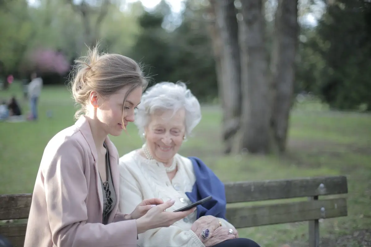 Adult daughter sitting with her mother at home